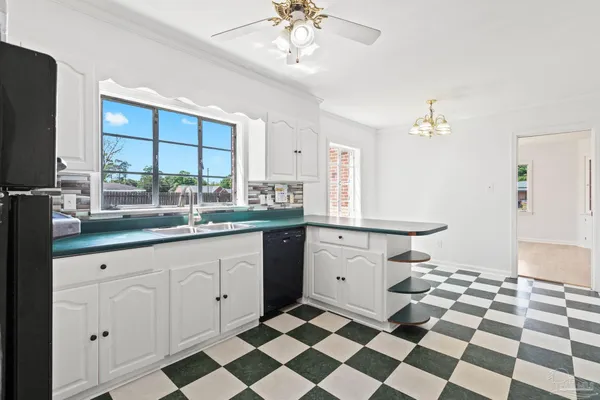 a view of a sink and table next to a window