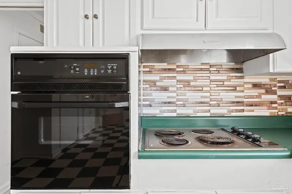 a kitchen with a sink a stove and a window