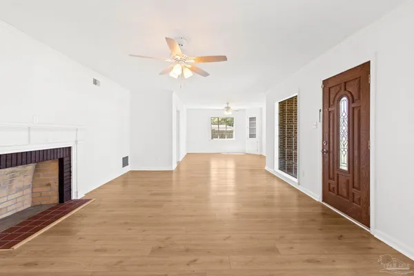 a view of empty room with window and fireplace