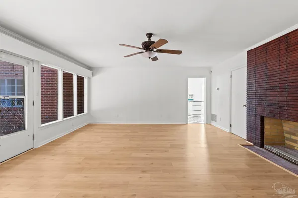 wooden floor in an empty room with a window