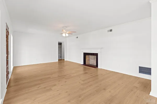 a kitchen with a checkered floor and white cabinets