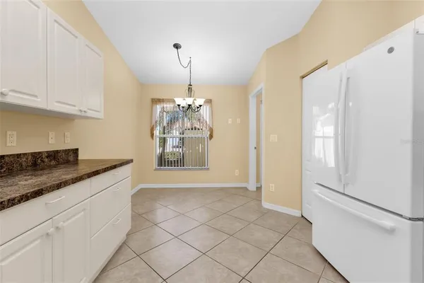 a kitchen with granite countertop white cabinets and white appliances