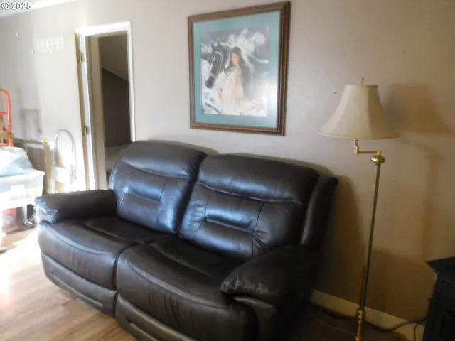 a living room with furniture and a painting on the wall