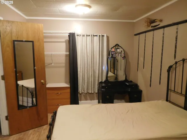 a bedroom with a bed and a dresser