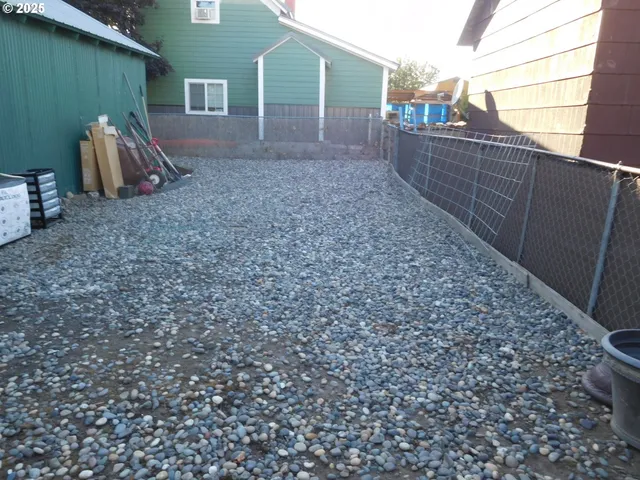 a view of a backyard with table and chairs