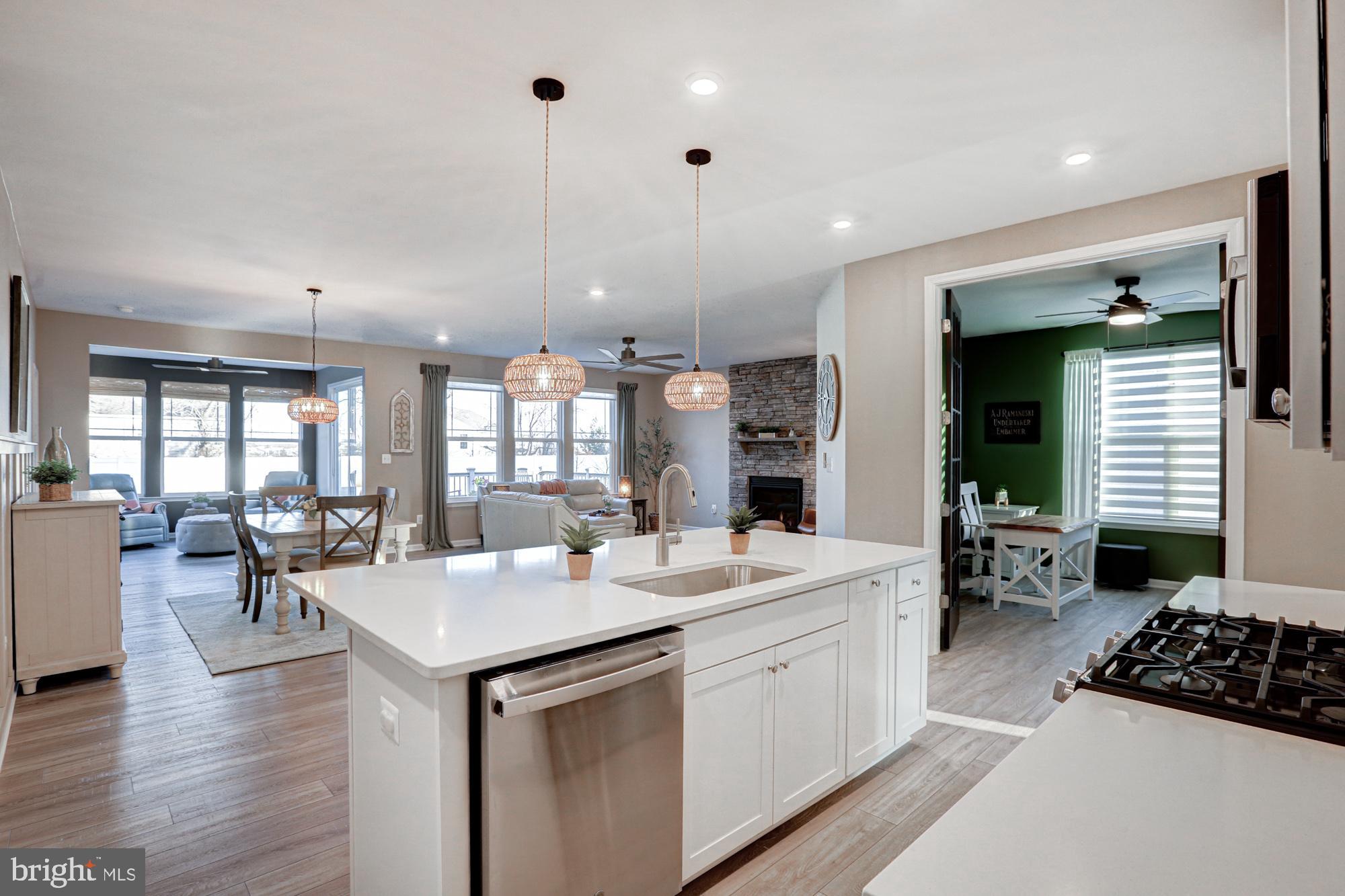 507 Cherry Bark Road Middletown, DE 19709 - Photo 22 of 81 a large white kitchen with a large window a sink stainless steel appliances and cabinets