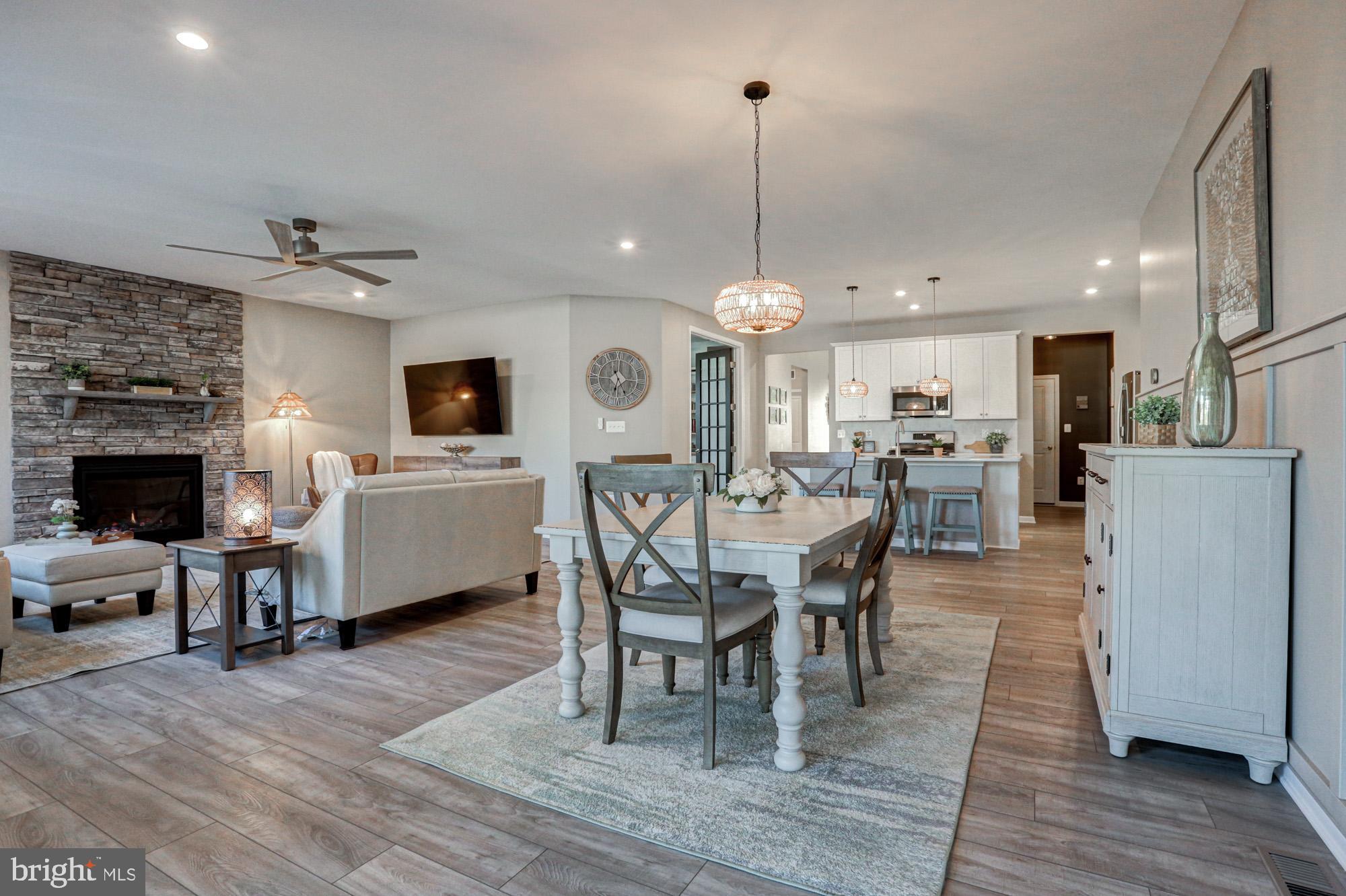 507 Cherry Bark Road Middletown, DE 19709 - Photo 26 of 81 a living room with furniture a fireplace and kitchen view