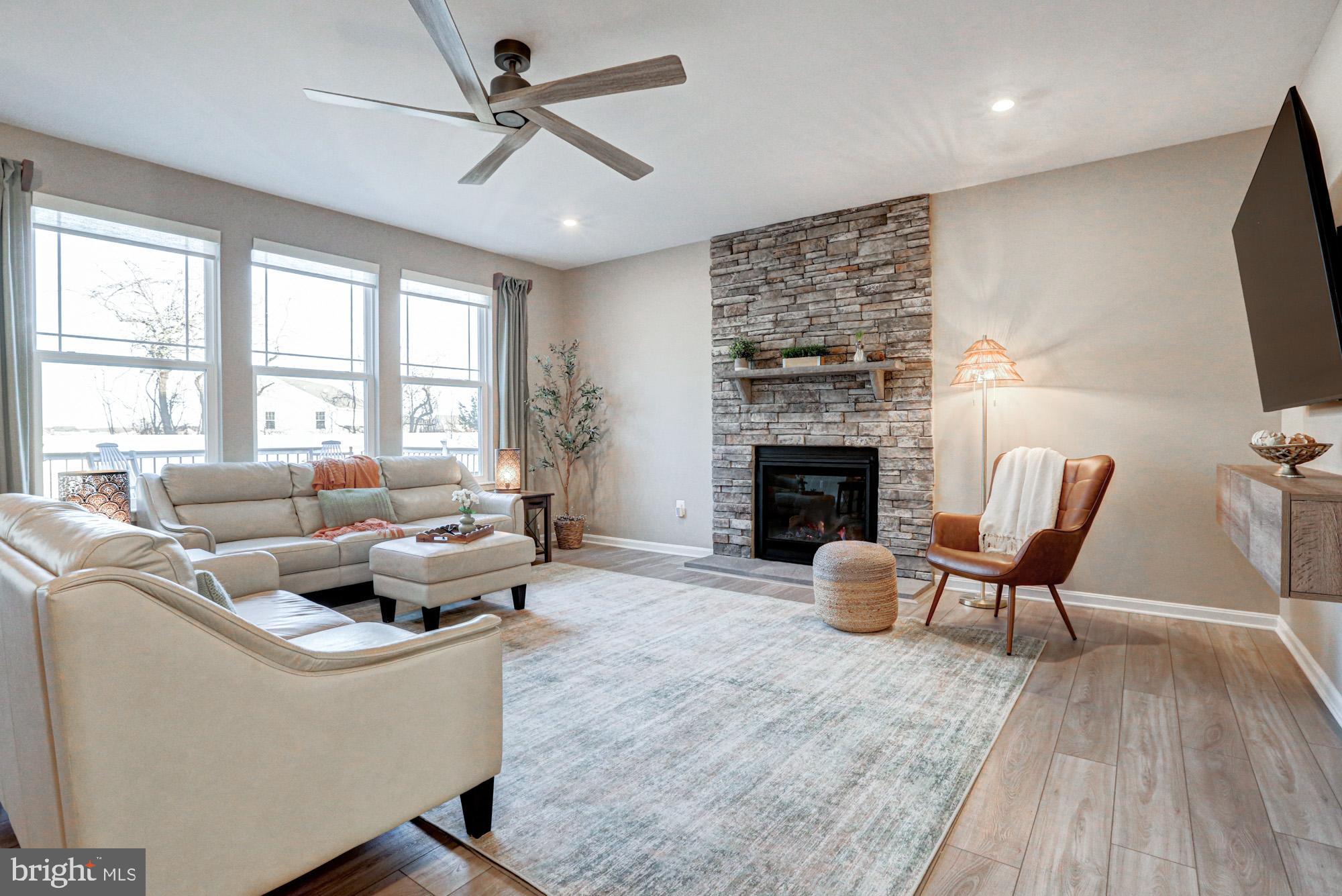 507 Cherry Bark Road Middletown, DE 19709 - Photo 31 of 81 a living room with furniture a fireplace and a flat screen tv