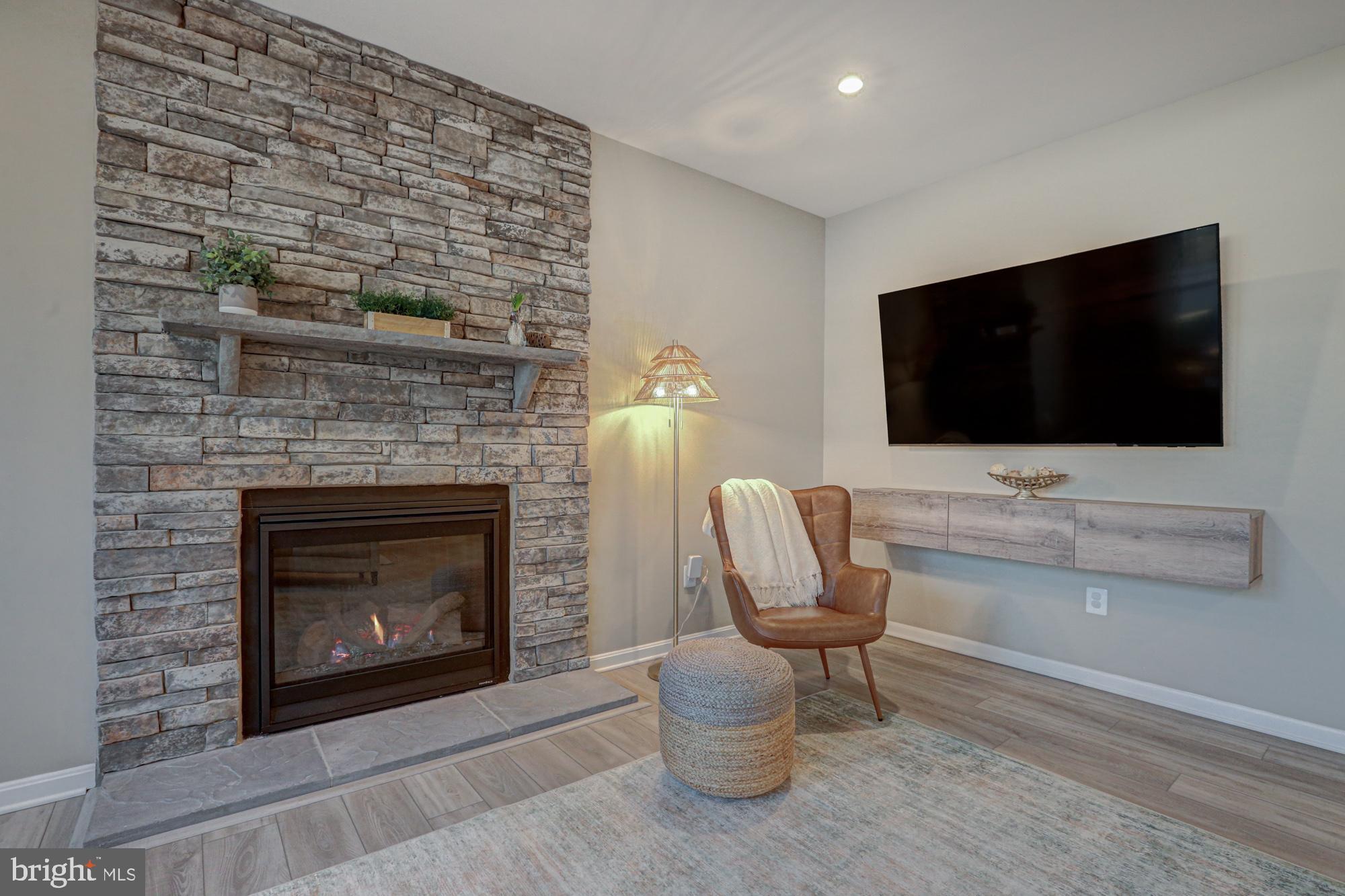 507 Cherry Bark Road Middletown, DE 19709 - Photo 33 of 81 a living room with furniture a flat screen tv and a fireplace