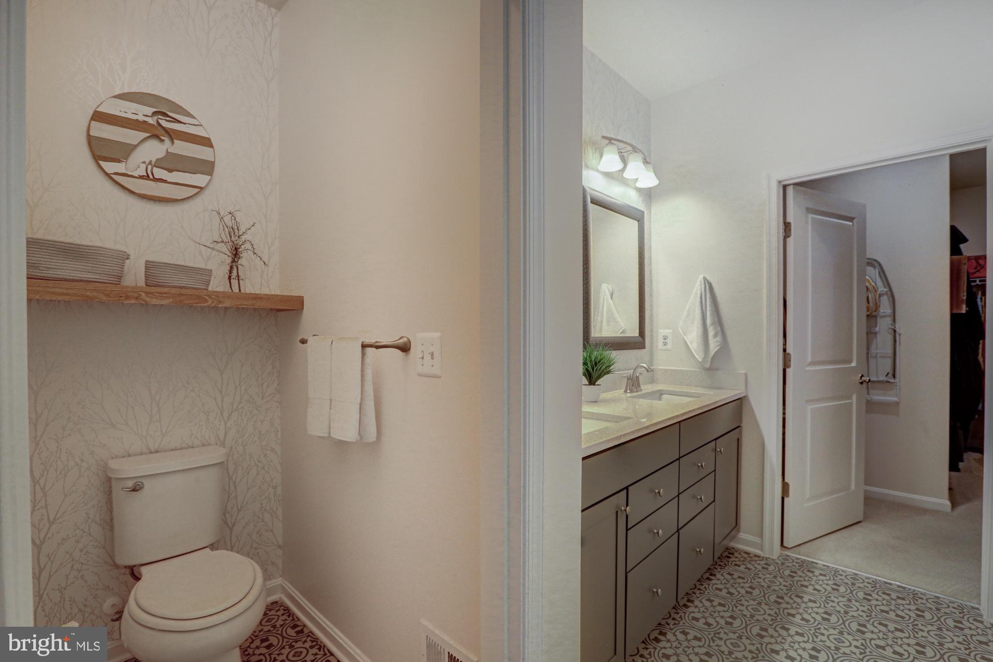 507 Cherry Bark Road Middletown, DE 19709 - Photo 45 of 81 a bathroom with a granite countertop sink a toilet and a mirror