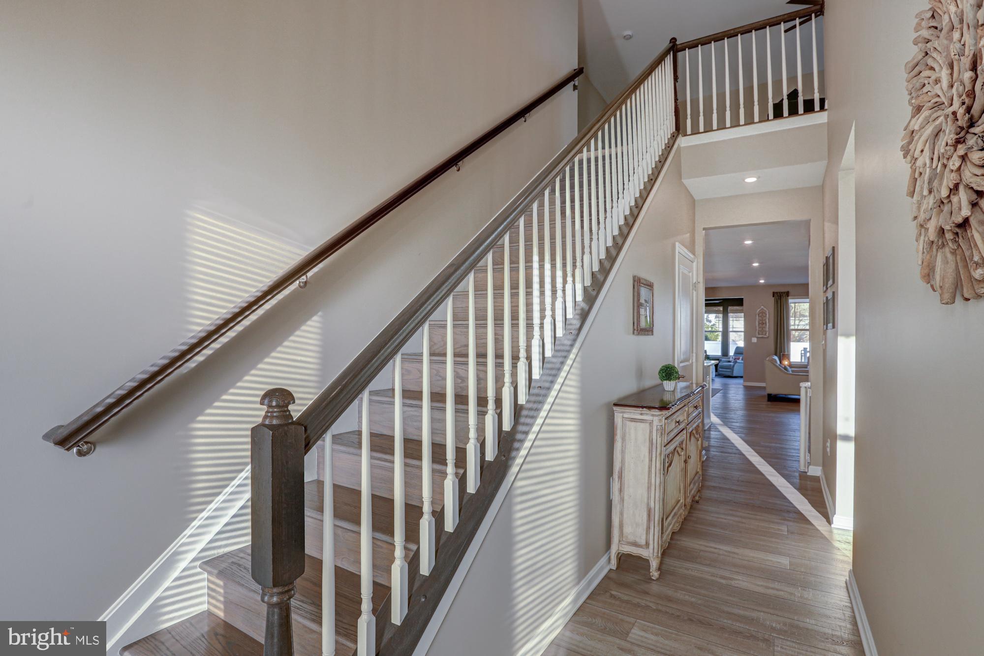 507 Cherry Bark Road Middletown, DE 19709 - Photo 57 of 81 a view of staircase with lots of frames on wall and wooden floor