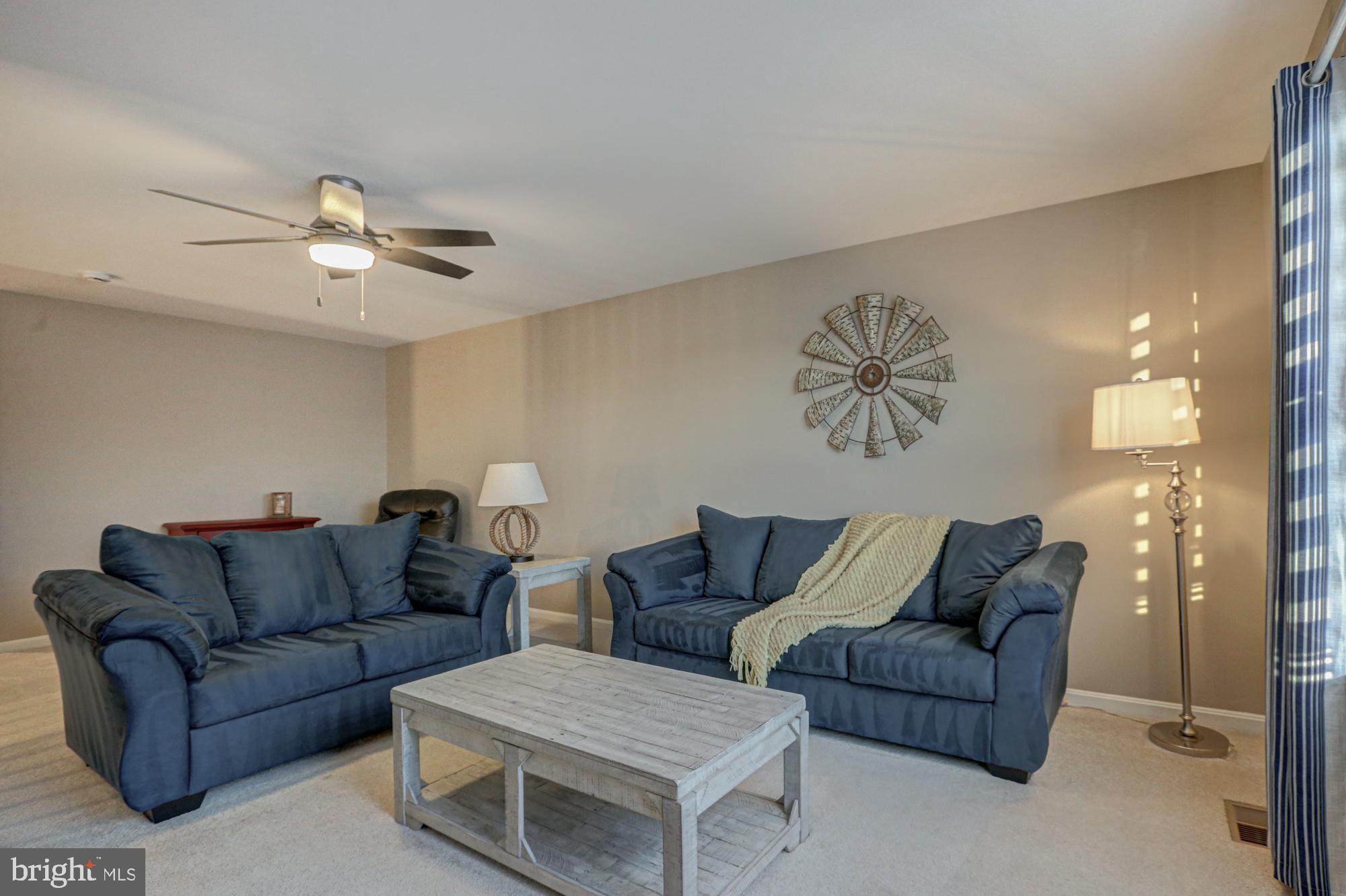 507 Cherry Bark Road Middletown, DE 19709 - Photo 60 of 81 a living room with furniture a ceiling fan and a rug