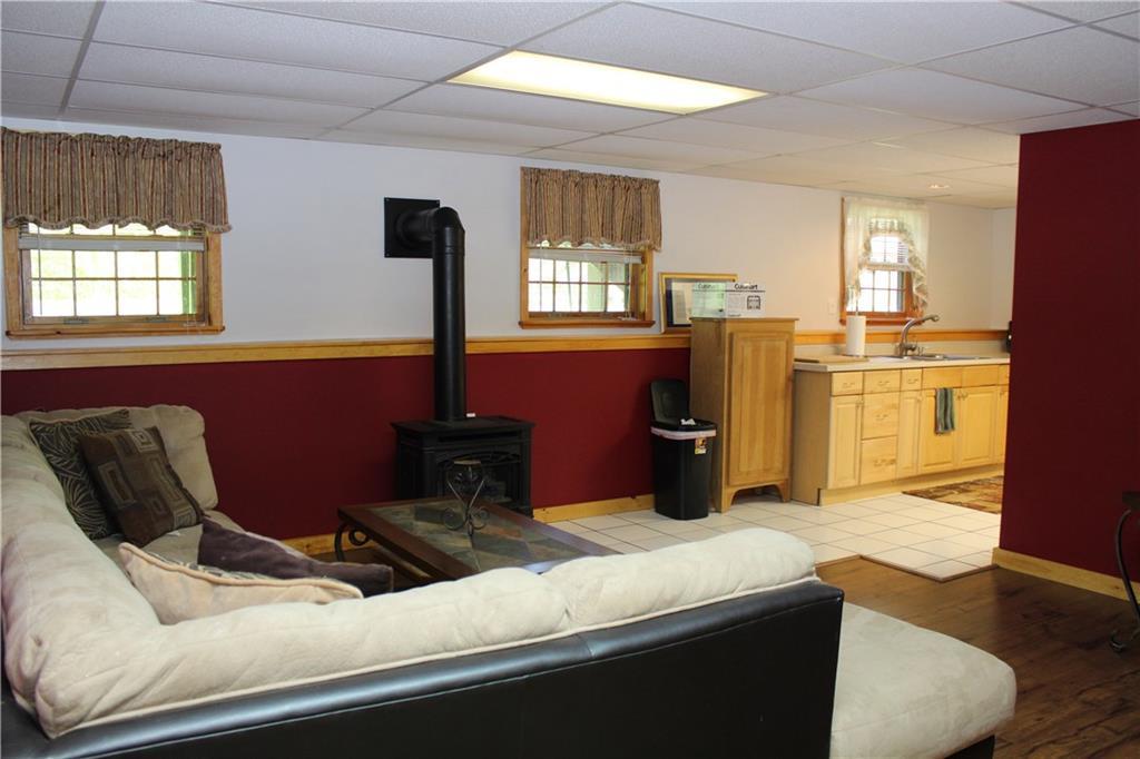 611 Borough Road Chesterville, ME 04938 - Photo 32 of 35 Basement living room with propane stove.