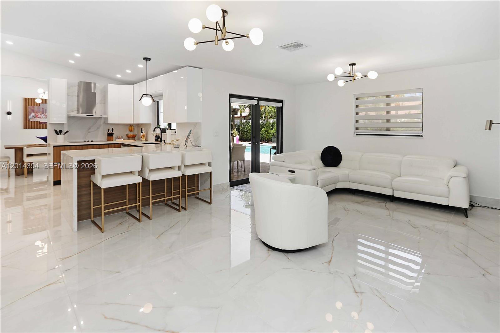 14211 Southwest 31st Street Miami, FL 33175 - Photo 18 of 27 a living room with furniture and a dining table with kitchen view