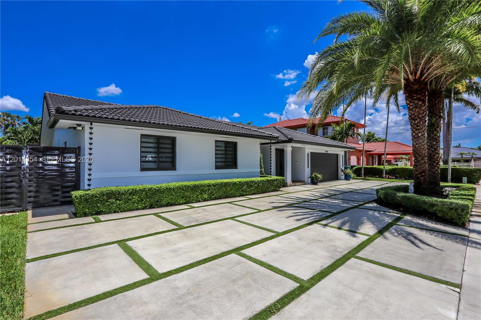 14211 Southwest 31st Street Miami, FL 33175 - Photo 2 of 27 a front view of a house with a garden