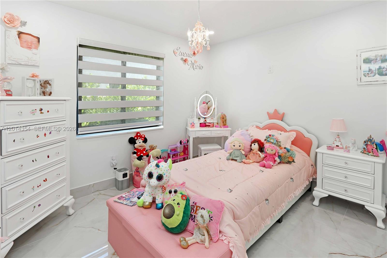14211 Southwest 31st Street Miami, FL 33175 - Photo 24 of 27 a bedroom with a bed and chandelier