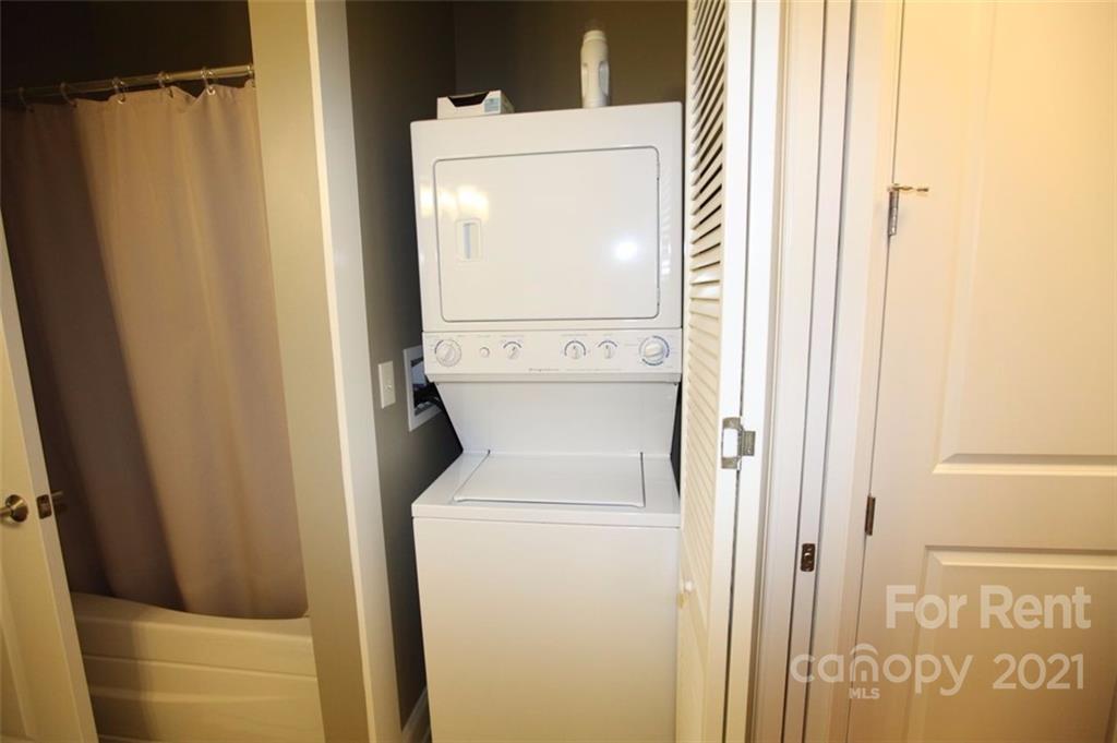 230 South Tryon Street, Unit 304 Charlotte, NC 28281 - Photo 13 of 17 a utility room with dryer and washer