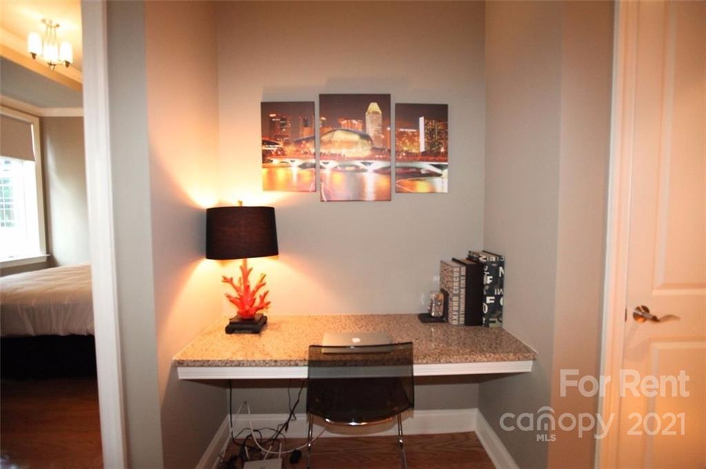 230 South Tryon Street, Unit 304 Charlotte, NC 28281 - Photo 5 of 17 a workspace with furniture and window