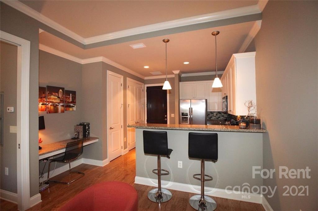 230 South Tryon Street, Unit 304 Charlotte, NC 28281 - Photo 6 of 17 a view of a room with gym equipment
