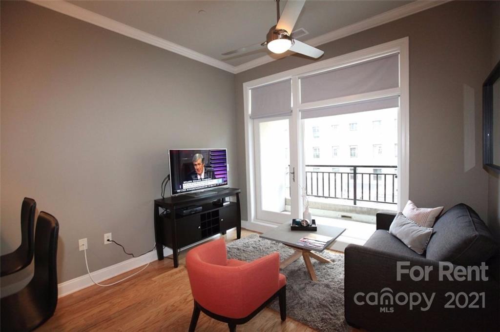 230 South Tryon Street, Unit 304 Charlotte, NC 28281 - Photo 9 of 17 a living room with furniture and a window
