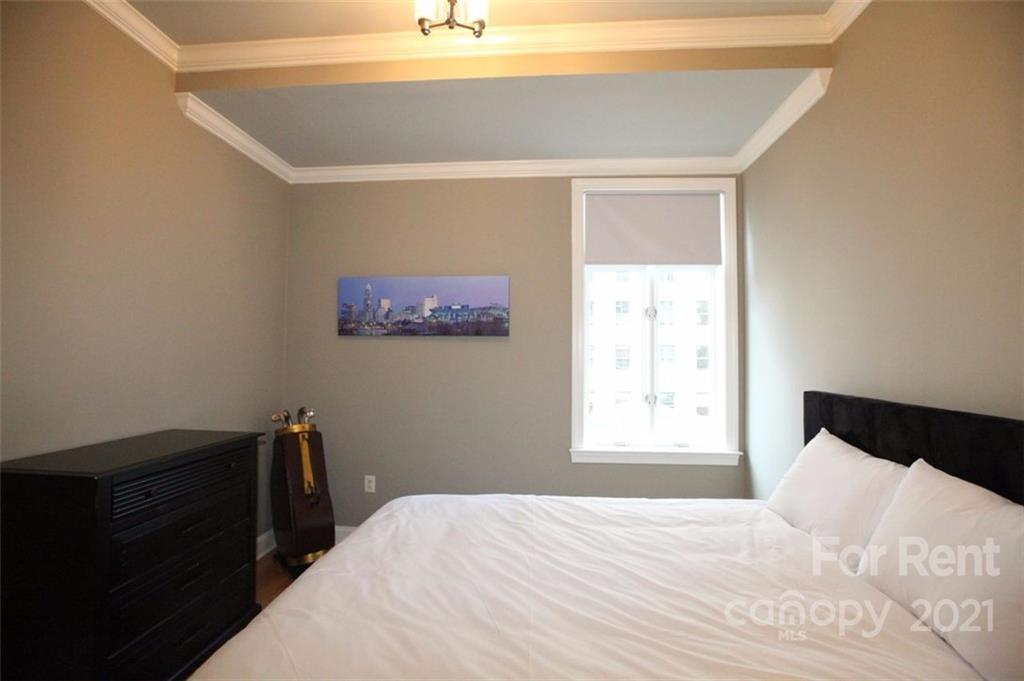 230 South Tryon Street, Unit 304 Charlotte, NC 28281 - Photo 10 of 17 a bedroom with a bed and a window