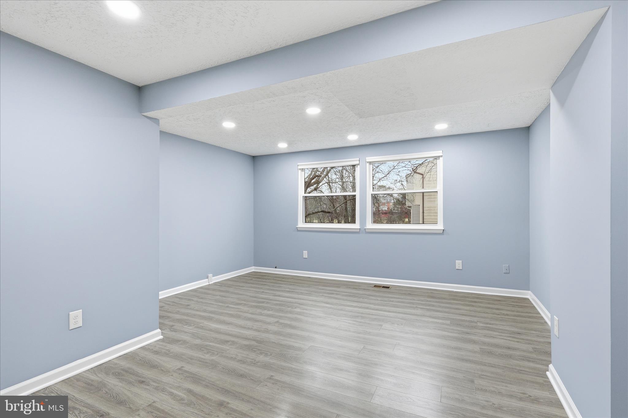 307 Brethour Court Sterling, VA 20164 - Photo 10 of 43 a view of an empty room with wooden floor and a window