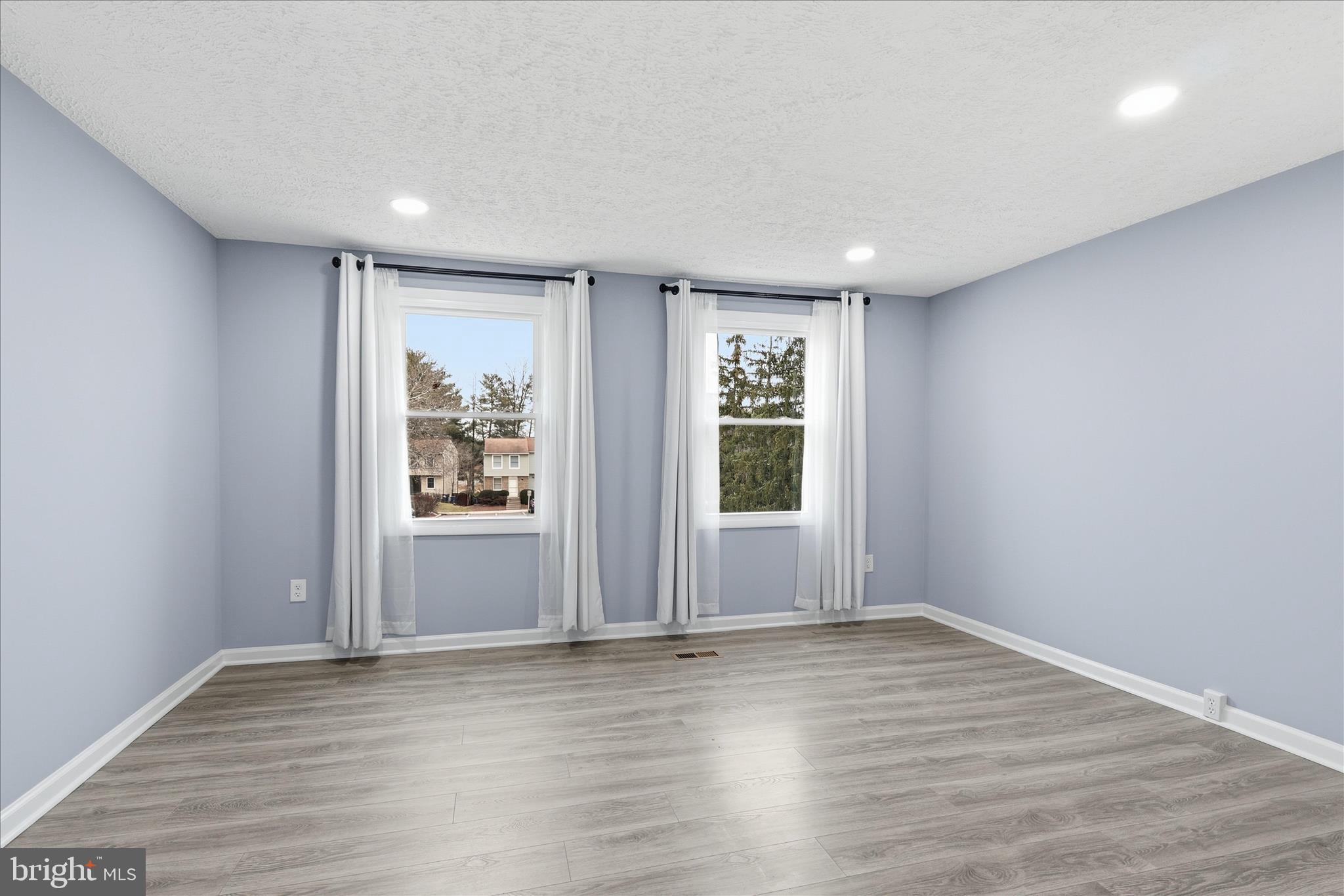 307 Brethour Court Sterling, VA 20164 - Photo 14 of 43 wooden floor in an empty room with a window