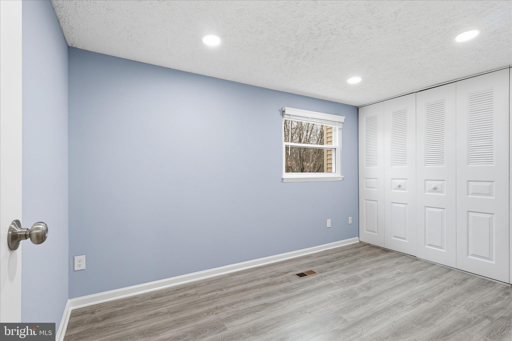 307 Brethour Court Sterling, VA 20164 - Photo 17 of 43 an empty room with wooden floor and window