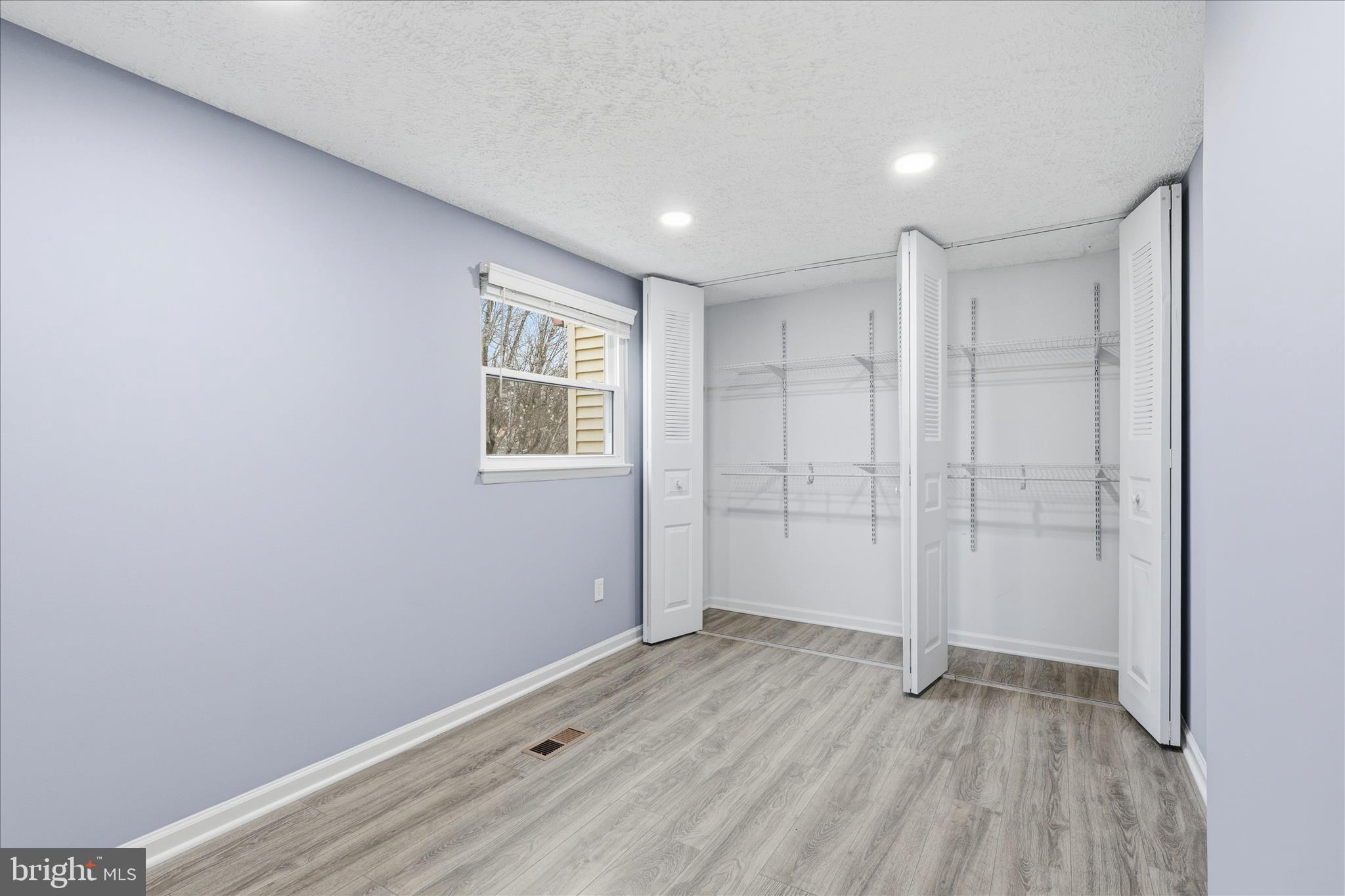 307 Brethour Court Sterling, VA 20164 - Photo 18 of 43 a view of an empty room with wooden floor