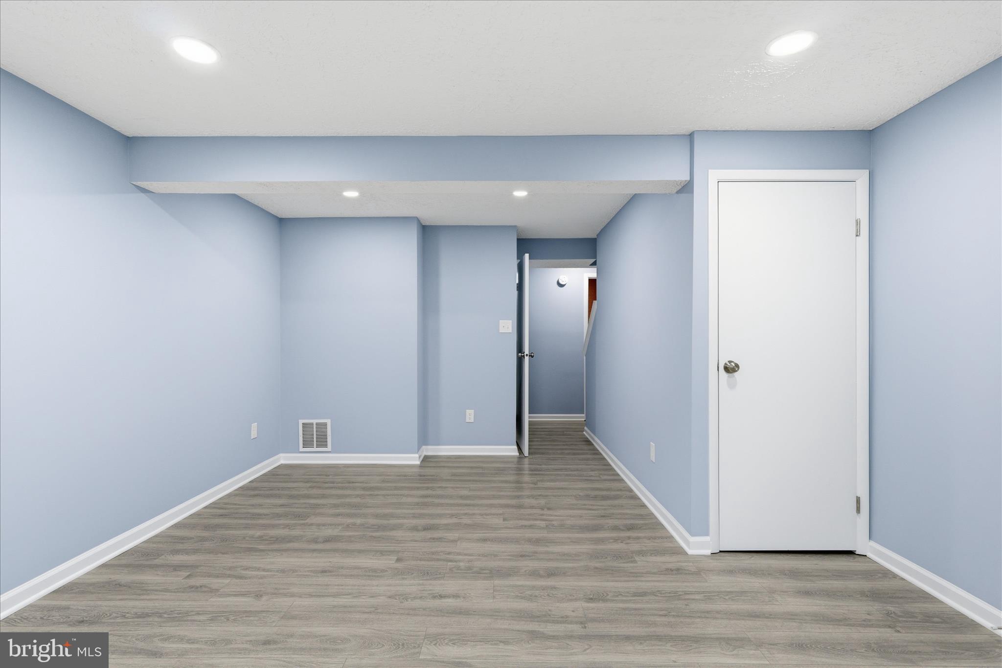 307 Brethour Court Sterling, VA 20164 - Photo 23 of 43 a view of an empty room with wooden floor