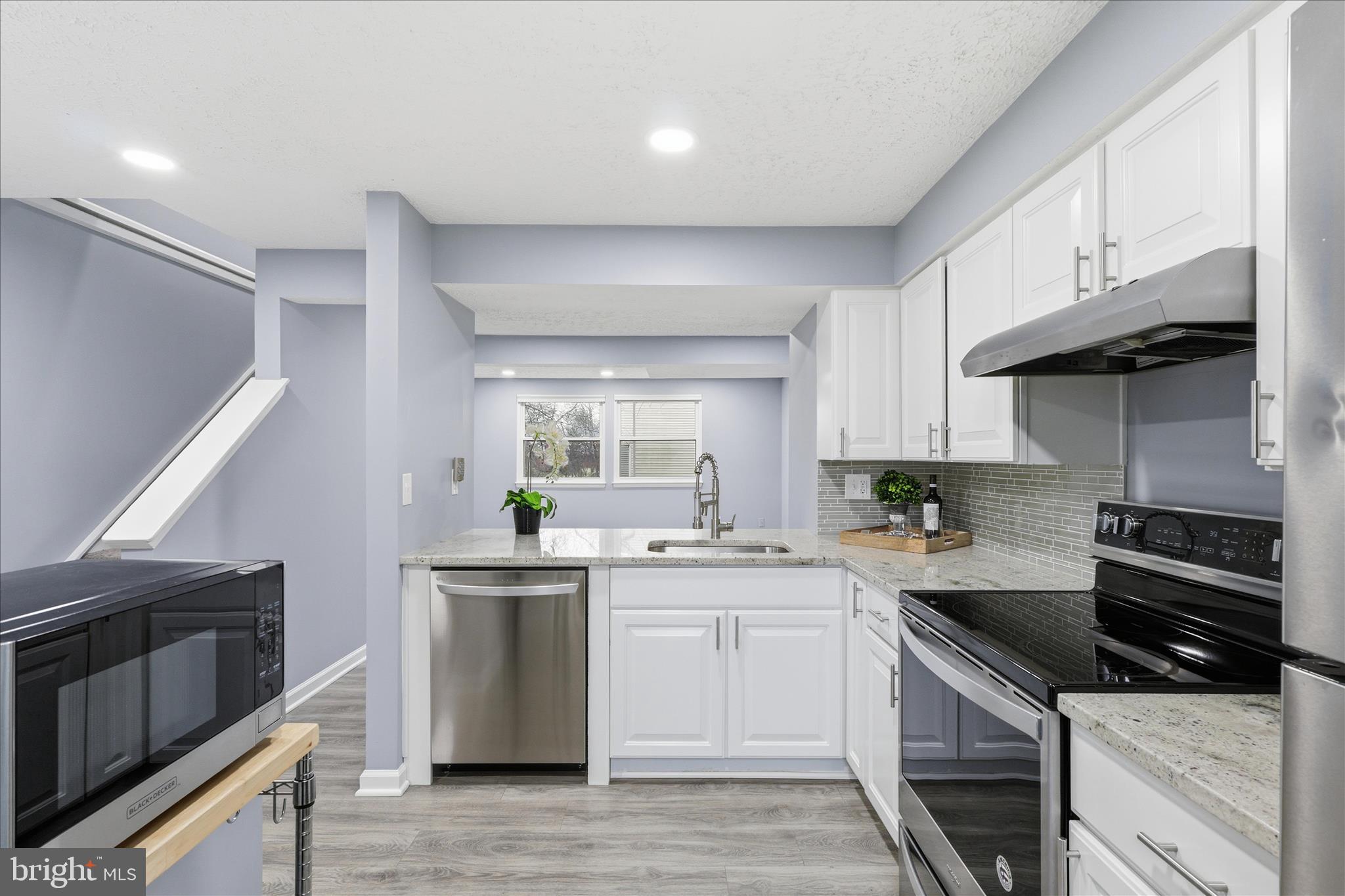 307 Brethour Court Sterling, VA 20164 - Photo 8 of 43 a kitchen with stainless steel appliances granite countertop a sink stove and refrigerator