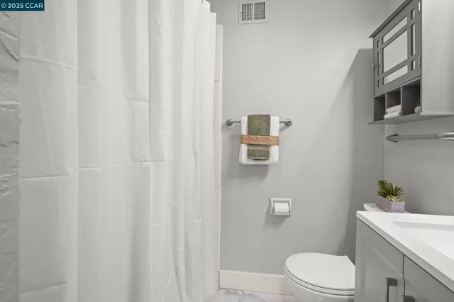 a white toilet sitting next to a bathroom sink