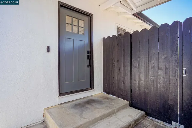 a view of a hallway with wooden floor and cabinet