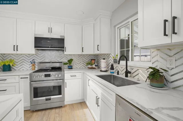 a kitchen with cabinets a sink and appliances