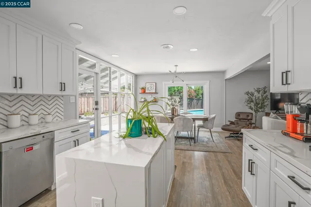 a open kitchen with stainless steel appliances granite countertop a lot of counter space and a sink