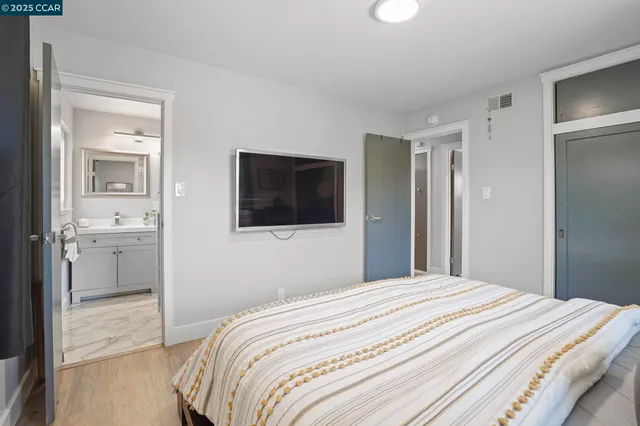 a bedroom with a bed and a bathroom