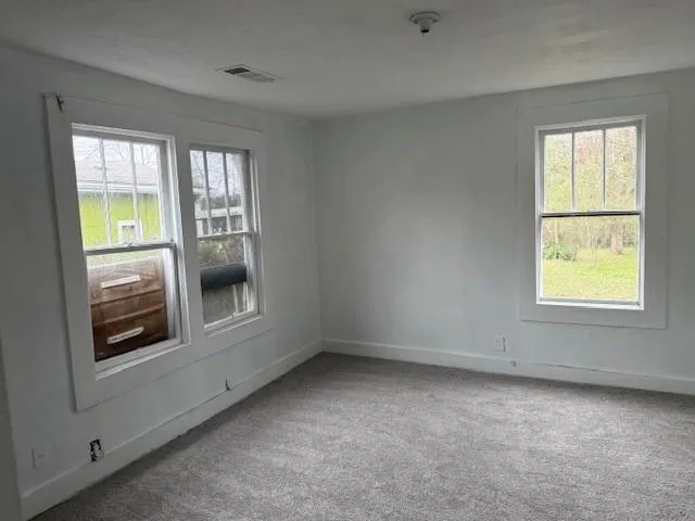 wooden floor and window in an empty room