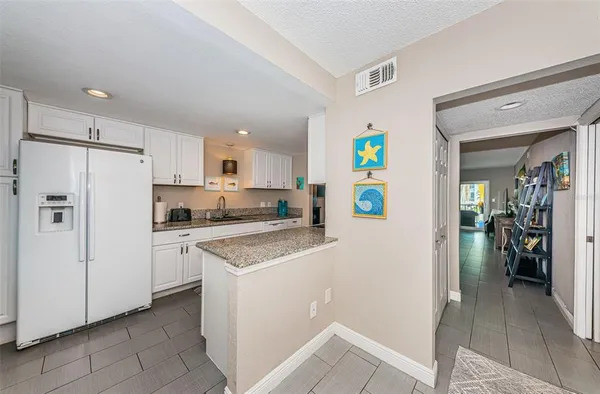 a kitchen with a refrigerator a stove top oven and a refrigerator