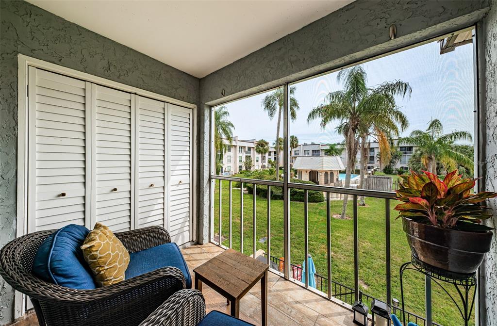 8699 Bardmoor Boulevard, Unit 203 Seminole, FL 33777 - Photo 4 of 14 a living room filled with furniture and a potted plant