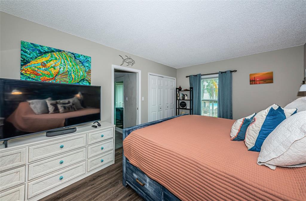 8699 Bardmoor Boulevard, Unit 203 Seminole, FL 33777 - Photo 7 of 14 a bedroom with a bed and a flat screen tv