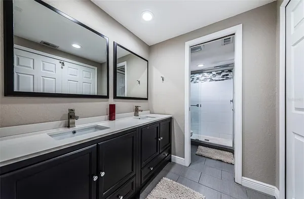 a bathroom with a sink a toilet and mirror