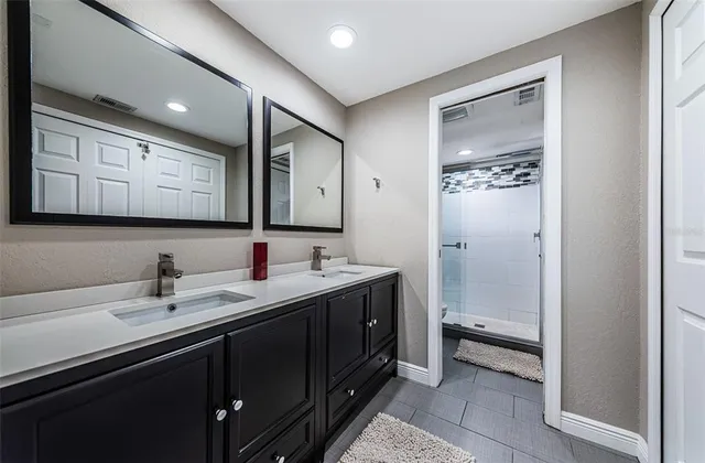 a bathroom with a sink a toilet and mirror