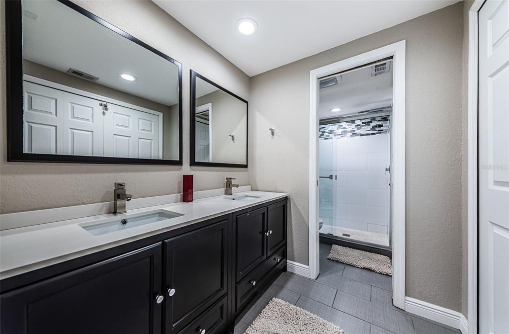 8699 Bardmoor Boulevard, Unit 203 Seminole, FL 33777 - Photo 8 of 14 a bathroom with a sink a toilet and mirror