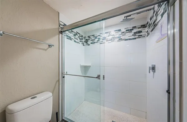 a bathroom with a shower a toilet and sink