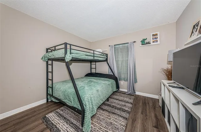 a bedroom with a bed and a mirror