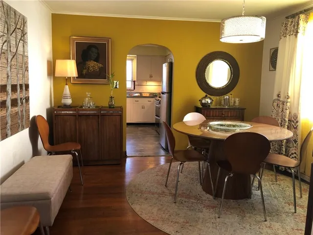 a kitchen with stainless steel appliances a stove a sink and white cabinets