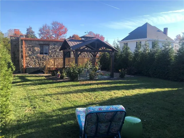 a view of an outdoor dining space with a table and chairs