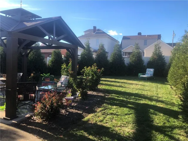a living room with furniture and a mirror