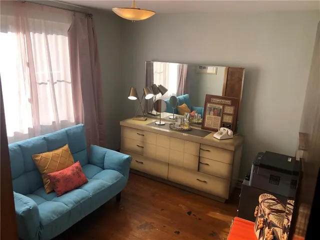 a view of a backyard of a house with a lots of plants and a fountain