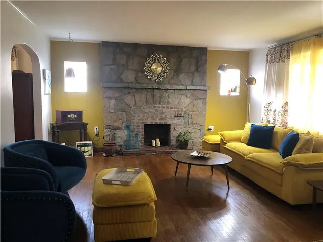 a living room with furniture and a clock